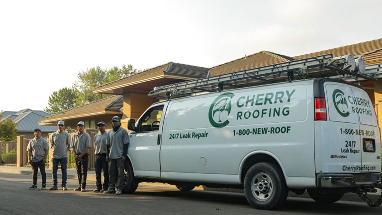 A Cherry Roofing van with a roofing crew in front of a completed job in Vancouver, Washington.