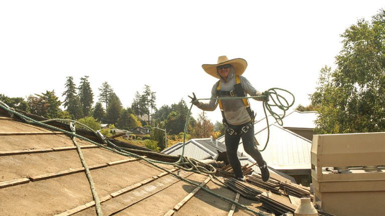 A Cherry Roofing crew member hard at work on a roof.