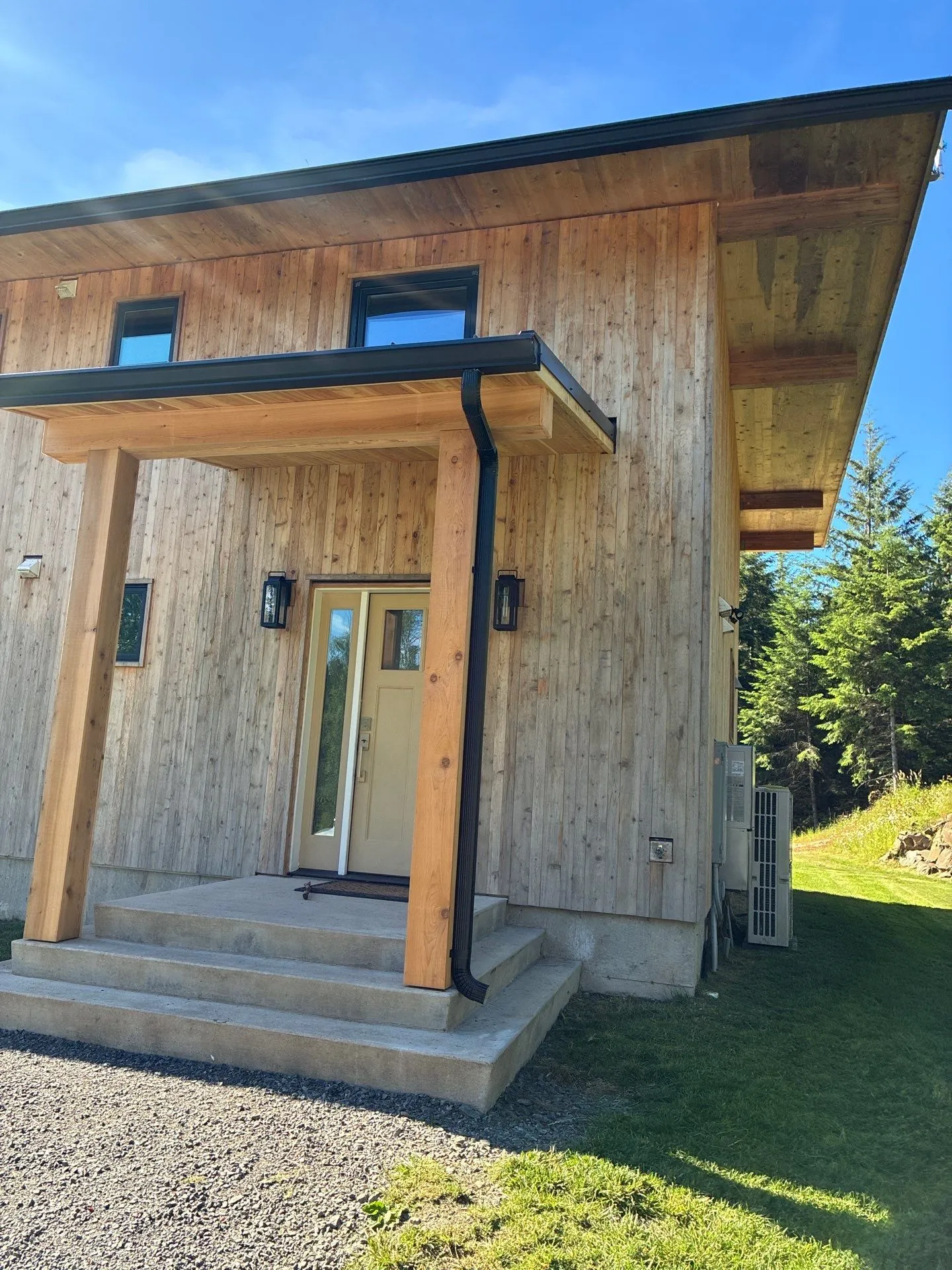 Black gutter and downspout installed on a covered entryway in Vancouver, WA