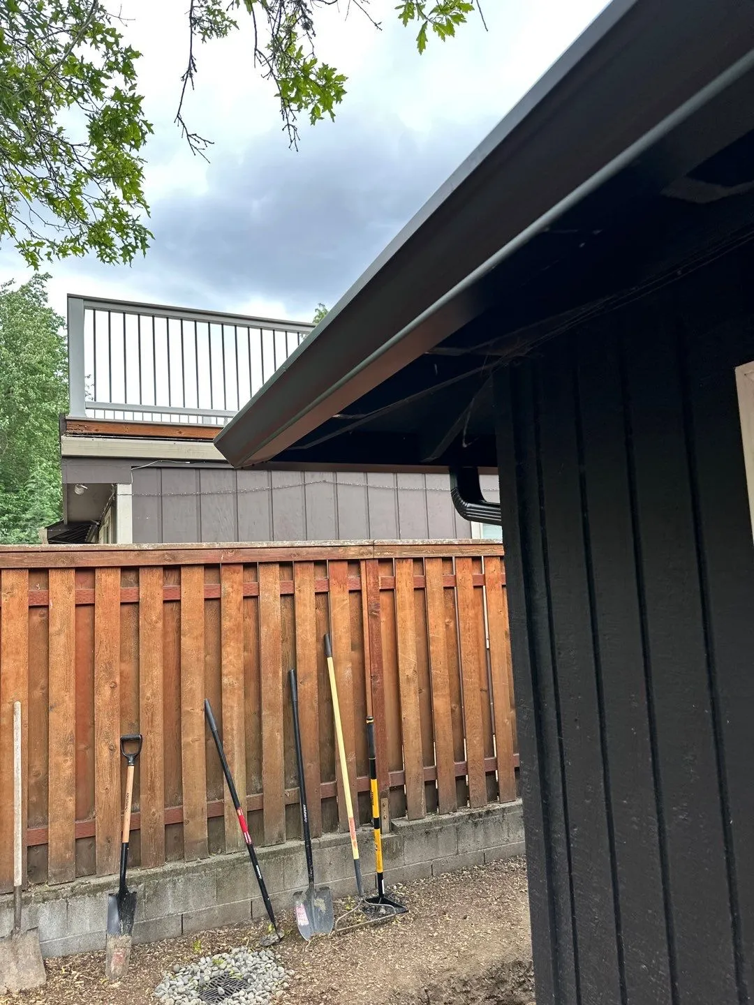 Residential gutter connected to a downspout along the roofline of a Vancouver, WA home